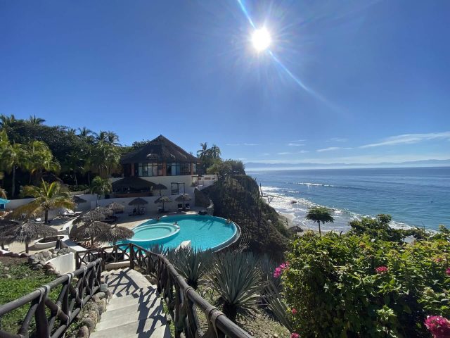 View of the Grand Palladium Vallarta Resort along the coast in Mexico on a bright sunny day | Ethical concerns of all-inclusives on Wanderful