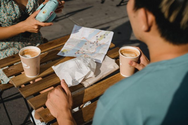 Two people sitting at a table with coffees